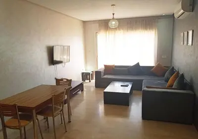 a living room with a couch and a table at Skyline Studios Hivernage in Marrakech