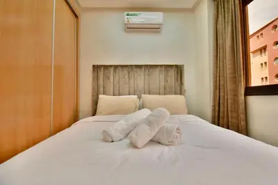 a bed with two towels on top of it at Central and Cozy Gem Balcony in Marrakech
