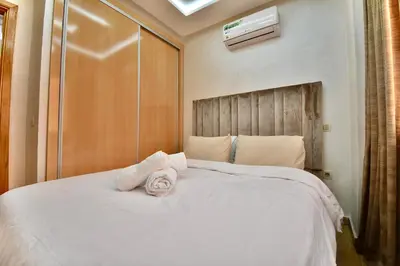 a bedroom with a white bed with a towel on it at Central and Cozy Gem Balcony in Marrakech
