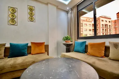 a living room with a couch and a table at Central and Cozy Gem Balcony in Marrakech