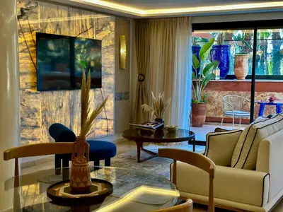 a living room with a couch and a table at Yves Saint Laurent Jacuzzi Elegance in Marrakech