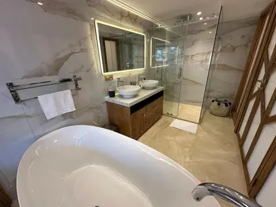a bathroom with a tub and a sink and a shower at Yves Saint Laurent Jacuzzi Elegance in Marrakech