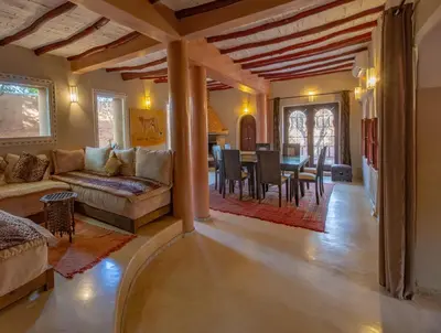 a living room with a couch and a table at Villa Ferme de Coco in El Caïd Omar