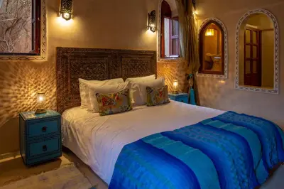 a bedroom with a large bed with two pillows at Villa Ferme de Coco in El Caïd Omar