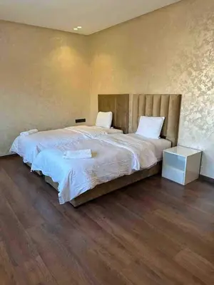 a bedroom with a large bed and a wooden floor at Villa in Urban Morocco, Marrakech in Marrakech