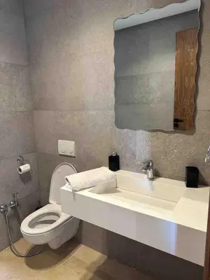 a bathroom with a white toilet and a sink at Villa in Urban Morocco, Marrakech in Marrakech