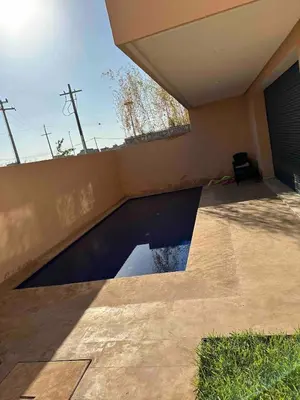 a swimming pool in the side of a house at Villa in Urban Morocco, Marrakech in Marrakech