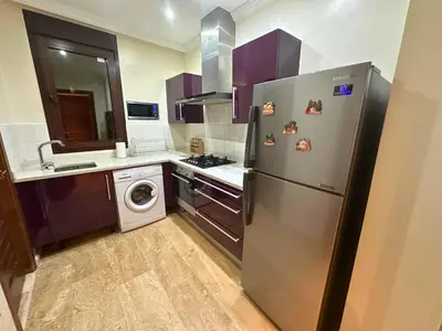 a kitchen with a stainless steel refrigerator and a dishwasher at Somptueux Appartement avec Jacuzzi Privé Marrakech in Marrakech