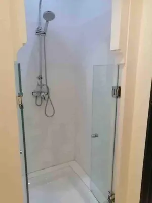 a shower with a glass door in a bathroom at Marrakech River Palm in Dar Caïd Layadi