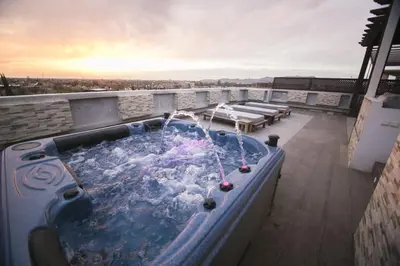a jacuzzi tub on a balcony with a view at Marrakech River Palm in Dar Caïd Layadi