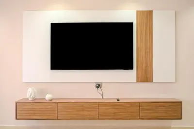 a television on a wall above a wooden dresser at Luxury 2BD in Prestigia Jade with Pool and Golf View in Marrakech
