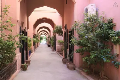 an alley with an archway in a building with potted plants at big house with swiming pool in Marrakech