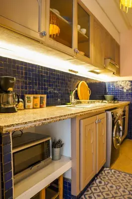 a kitchen with a sink and a microwave at Charm & Comfort in Majorelle, Close to YSL Museum in Marrakech