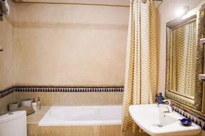 a bathroom with a tub and a sink and a toilet at Charm & Comfort in Majorelle, Close to YSL Museum in Marrakech