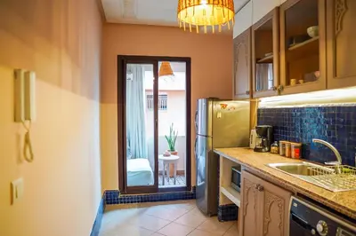 a kitchen with a sink and a refrigerator at Charm & Comfort in Majorelle, Close to YSL Museum in Marrakech
