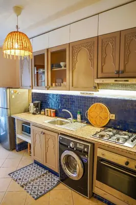 a kitchen with a washing machine and a sink at Charm & Comfort in Majorelle, Close to YSL Museum in Marrakech