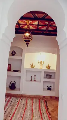 a room with white shelves and a chandelier at Quite riad in Marrakech