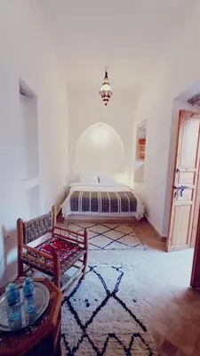 a room with a bed in the corner of a room at Quite riad in Marrakech