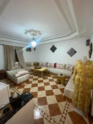 a living room with a couch and a checkered floor at Suite 1 in Marrakech