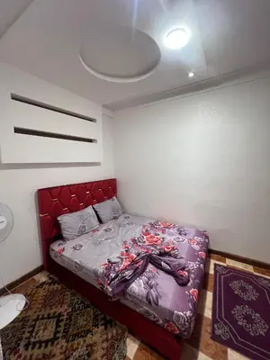 a bedroom with a bed with a red headboard at Suite 1 in Marrakech