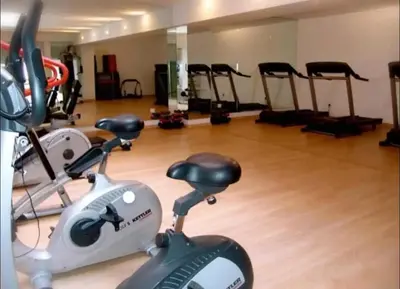 a gym with several treadmills and exercise bikes at Modern Studio with Pool in Central Gueliz in Marrakech