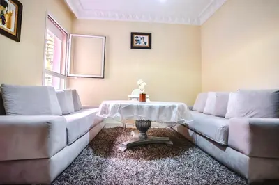 a living room with two couches and a table at Modern Studio with Pool in Central Gueliz in Marrakech