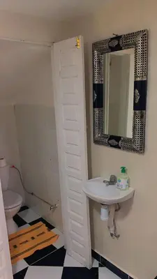 a bathroom with a sink and a mirror and a toilet at Maison Mariam in Marrakech