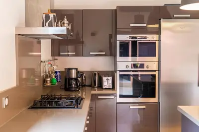 a kitchen with stainless steel appliances in a kitchen at Villa Anna - Havre de paix in Oulad Ikhia
