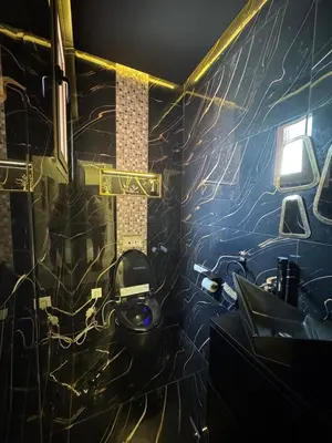 a bathroom with a toilet and a wall covered in graffiti at Beautiful new modern house with full comfort in Marrakech