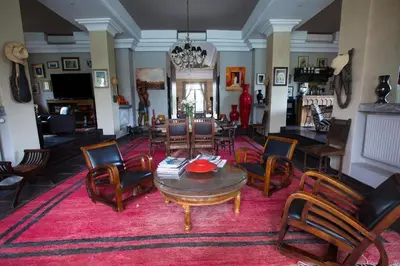 a living room with a table and chairs at Dar abie in Sraghna
