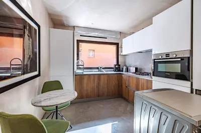 a kitchen with a table and chairs and a counter at Luxury 1 BDR Hivernage in Marrakech