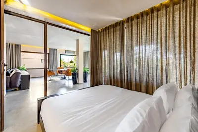 a bedroom with a large white bed and sliding glass doors at Luxury 1 BDR Hivernage in Marrakech