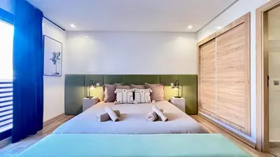 a bedroom with a large bed with two pillows at Luxueux DUPLEX au cœur Marrakech in Marrakech