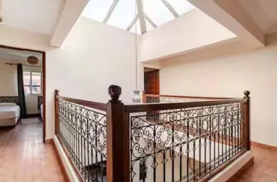 a balcony with a wooden railing and a skylight at Golden Palm 2 in Marrakech