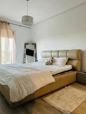 a bedroom with a large bed with a large headboard at Atrani1 happy holiday in Marrakech