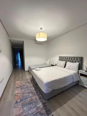 a bedroom with a large bed and a table at Atrani1 happy holiday in Marrakech