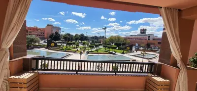 a balcony with a view of a park at La Plaza cœur de Gueliz in Marrakech