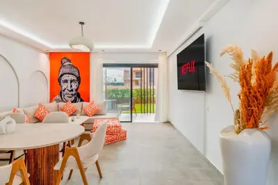 a living room with a couch and a table at Le Noria - Super logement Jardin & Piscine - Golf in Marrakech