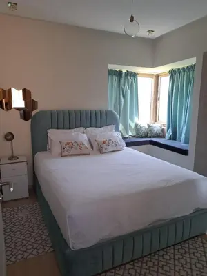 a bedroom with a large bed with pillows and a window at Prestigious residence marrakech with optical fiber in Marrakech