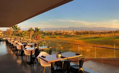a row of tables and chairs at a restaurant at Prestigious residence marrakech with optical fiber in Marrakech