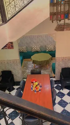 a table and chairs in a room with a table at Raid lkaram in Marrakech