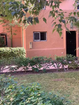 a pink building with a window and a door at Raid lkaram in Marrakech