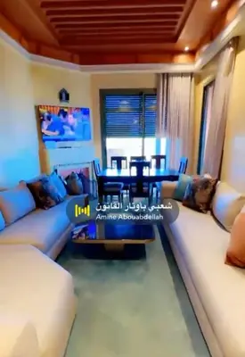 a living room with a couch and a table at Appartement La Palmeraie in Marrakech