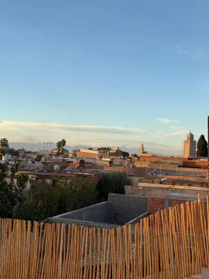 a view of a city behind a wooden fence at Riad Dar Sary Marrakech médina privé 3 chambres in Marrakech