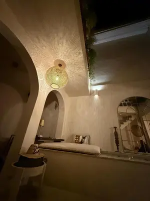 a bathroom with a bed and a large mirror at Riad Dar Sary Marrakech médina privé 3 chambres in Marrakech