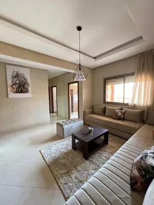 a living room with a couch and a coffee table at Appartement raffiné avec piscine au centre ville in Marrakech