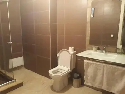 a bathroom with a toilet and a sink at Appartement ZAHRA HOME in Marrakech