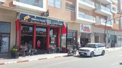 a white car parked in front of a building at Appartement ZAHRA HOME in Marrakech