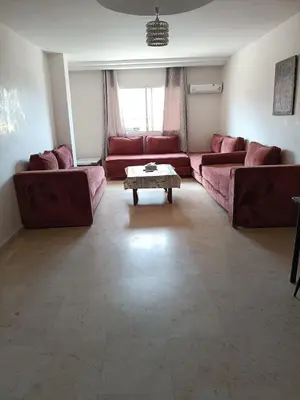 a living room with red couches and a coffee table at family apartment 8 in Marrakech