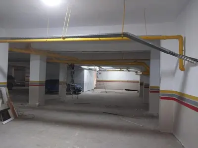 an empty parking garage with a yellow pole on the wall at Family apartment 22 in Marrakech